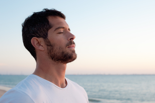 young man relaxed on beach.jpg.jpg