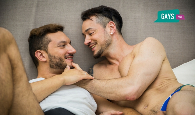 Gay male couple on the bed getting ready for sex