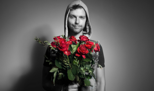 man holding a bunch of roses